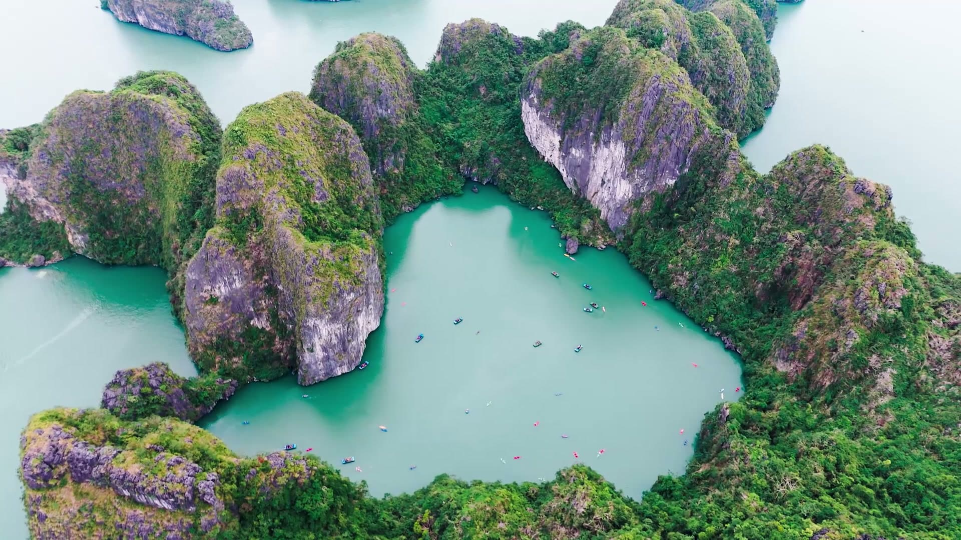 Kayakers exploring the limestone islands of Halong Bay